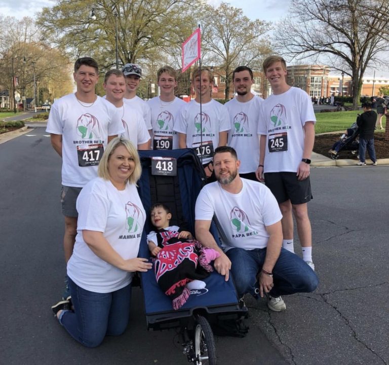 Brothers push wheelchair-enabled athlete in race