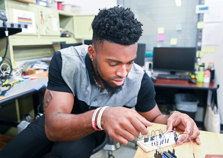 Football? Engineering? Wil Young chose both … and made history