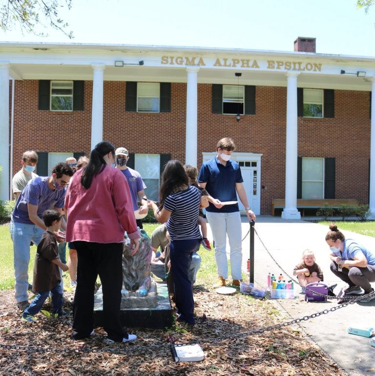 Kids find joy painting SAE lion statue