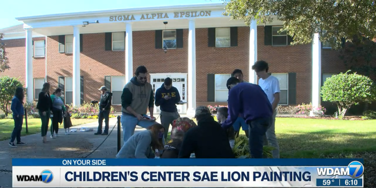 USM Children’s Center kids continue tradition painting SAE Fraternity lions
