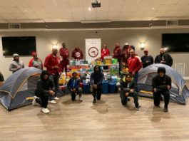 Kappa Alpha Psi members with donations and tents to raise homelessness awareness.