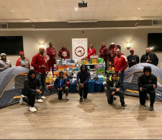 Kappa Alpha Psi members with donations and tents to raise homelessness awareness.