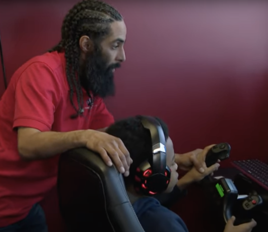 Instructor teaches young student using a flight simulator.