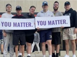 Sigma Pi fraternity members holding signs at a you matter event.