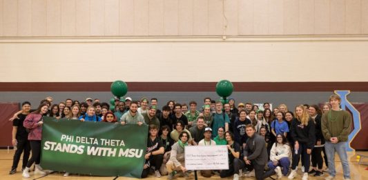 Group photo of all attendees at Phi Delta Theta's Celebration of Life event for Brian Fraser in the Sun Devil Fitness Complex in Tempe.