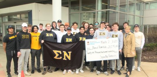 Bradley fraternity hits the road for charity Members of Sigma Nu at Bradley Univ. present check to OSF Children's Hospital staff.