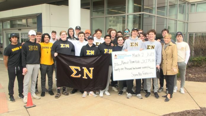 Members of Sigma Nu at Bradley Univ. present check to OSF Children's Hospital staff.