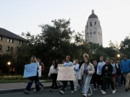 Students silently march past Hoover Tower to show solidarity for survivors of sexual assault on Tuesday evening. Photo: MARK ALLEN CU/The Stanford Daily.