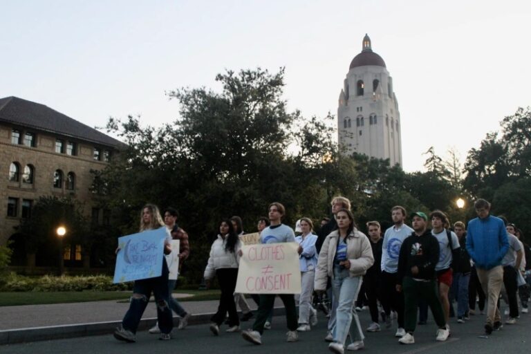 Students silently march past Hoover Tower to show solidarity for survivors of sexual assault on Tuesday evening. Photo: MARK ALLEN CU/The Stanford Daily.