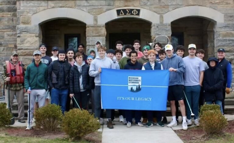 The Michigan Waterway Stewards and Delta Sigma Phi fraternity after their day cleaning up the Red Cedar River.