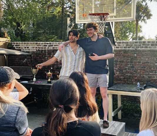 awson Bell, Alpha chapter Pi Kappa Phi philanthropy chair, and Brian Grazzini, Alpha chapter Pi Kappa Phi vice president, celebrate the College’s chapter of Alpha Delta Pi as the winner of the fraternity’s War of the Roses philanthropy competition. (Photo by Gavin Peters)