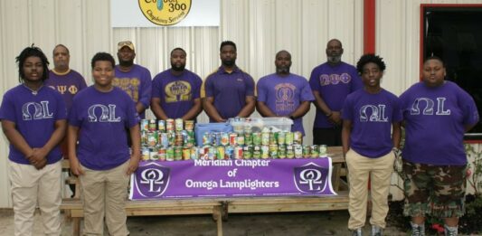 Omega Lamplighters collect food for Feed by Faith Members of the Omega Lamplighters, front row, and Omega Psi Phi Fraternity Inc., back row, stack food they collected during a food drive for Feed by Faith. Glenda Sanders / The Meridian Star