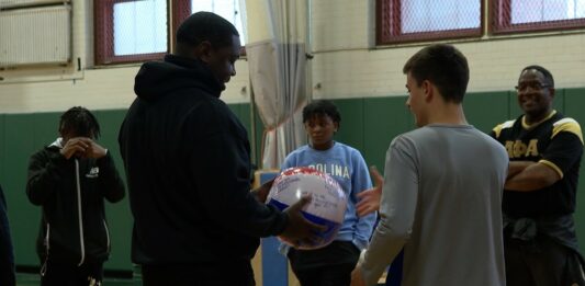Alpha Phi Alpha fraternity brothers with local youth.