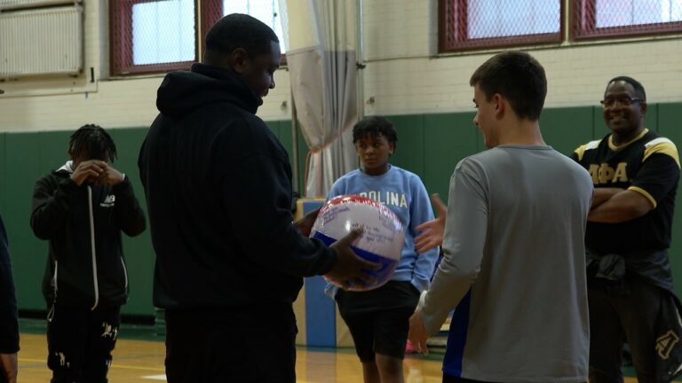 Alpha Phi Alpha fraternity brothers with local youth.
