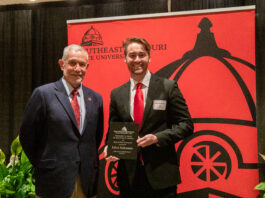 Elliot C. Siekmann poses for photo with award.